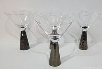 Four American Atelier Daphne martini glasses arranged in a row, showing their shape and size.