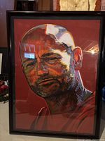 Framed colorful artistic portrait of Gord Downie in black frame with glass cover.