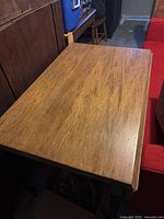Top view of rectangular wooden table showing natural wood grain and wear marks