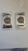 Two sealed Panini 2022 Basketball Hall of Fame collectible packs placed side by side on a white surface.