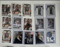 Full view of 18 Anthony Edwards rookie basketball cards on white cloth background, showing mix of Panini Optic, Prizm Draft Picks, Select, and Crusade series, all in protective sleeves.