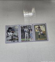 Three Bo Bichette rookie cards side by side in protective sleeves on white surface.