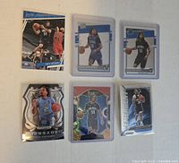Top view of six Cole Anthony rookie cards laid out, showing different Panini series including Prizm, Draft Picks, Select, and Crusade inserts with holographic effects.