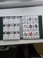 Binder showing front side of a page with multiple NHL player cards in plastic sleeves, illustrating condition and front design.