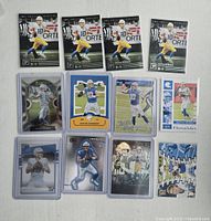 Photo shows 12 Justin Herbert rookie football cards arranged on a flat surface. Cards are sleeved and display Herbert in various action shots as quarterback for LA Chargers.