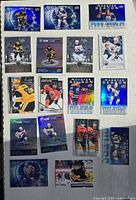 Top-down photo showing 16 hockey cards featuring NHL stars in various styles including Eckipitc, Monster Season, and Award Winners series.