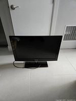 Front view of the Samsung 32-inch television on base stand with screen off.
