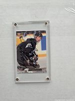 Close up of Wayne Gretzky hockey card autographed, showing player in black jersey