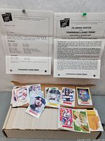 Photo of hockey cards spread out beside two printed notes on 'Tomorrow's Stars Today' letterhead showing information about the card series and error details.