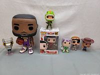 Photo of seven Funko Pop figures including LeBron James, Shazam, Buzz Lightyear, Woody and others