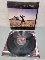 Vinyl record LP with album cover showing dance scene in field and house in background. Record with Columbia label displayed on sleeve.