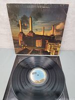 Full view of Pink Floyd Animals vinyl record with original sleeve in background.