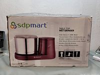 Box for SDPMART Table Top Wet Grinder showing model and features such as ABS body, 2L capacity, stainless steel drum, and attachments.