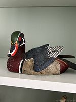 Side view showing detailed carving and coloration of the Wood Duck drake.