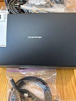 Top view of black Fujitsu ScanSnap device showing brand logo