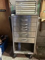 Full front view of stainless steel drawer unit on casters and file organizer stacked behind