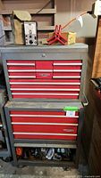Front view of red and gray two-piece Craftsman tool chest on caster wheels