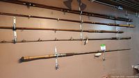Five rods mounted on wall, varying lengths