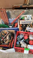 Boxes with various hand tools, hardware, and components including gloves and hand tools.