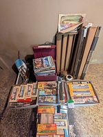 Overview of lot: file box with magazines, plastic containers of boxed cars, track stacks