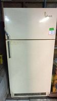 Front view of the vintage Coldspot refrigerator showing cream-colored exterior, two-door design, and metal handles.