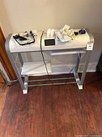 Photo of two AeroGarden units with accessories on top including control panel, seed pods, and cords, showing overall size and condition.