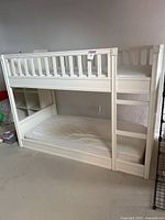 Full side view showing upper and lower bunks, integrated cubby shelf on left side, ladder on right