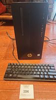 Front view of HP Pavillion Gaming Desktop with keyboard in foreground