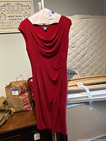 Red Ralph Lauren dress size 10 hanging on a hanger against a wall