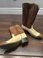 Photo of vintage cowgirl boots, size 8.5D, showing the boots side-by-side with intricate stitching and two-tone brown and cream colors.