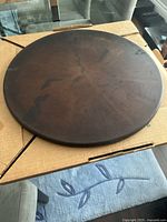 Top view of the round cooking stone showing age and use marks on the surface.