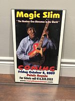 Framed Magic Slim poster featuring concert advertisement with image of artist holding guitar wearing blue shirt, text details event date Friday October 2, 2009 at Palais Royale, ticket info and website.