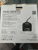 Box detailing specifications and features of Micro Drone 2.0 including battery, motor count, flight time, and controls