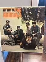 Front cover of the vinyl record album showing the album title 'The Best of The Animals' and a photo of the band members sitting and standing in a casual pose.