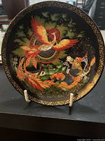 Front view of the Firebird Plate 9 with vibrant colors and gold detailing