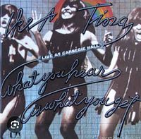 Front cover of Tina Turner 'What You Hear Is What You Get' double vinyl album showing performing artist and dancers with stylized text.