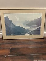 Framed print of a mountain lake landscape by Jerry Schurr, showing blues and grays with layered mountain silhouettes and water.