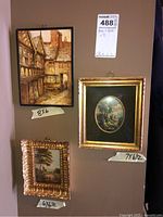 Three framed paintings hung on wall labeled with measurements: 8x6, 7x6.5, 6x6.5 inches