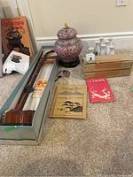 Overview of erhu, jar, sake set, paper and book on floor