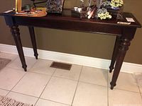 Full view of the Bombay Company hall table showing the rectangular top and turned legs.