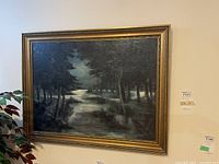 Full view of the framed landscape painting hanging on a wall