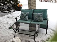 Double seater settee and coffee table on snowy porch