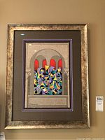 Full view of framed print showing silver-gold frame and matting