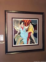 Overall view of framed Tarkay print hung on wall