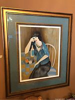 Framed print hanging at slight angle showing full composition