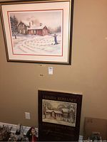 Signed limited edition framed print and framed poster print displayed on wall with both visible