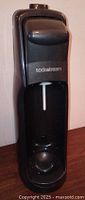 Front view of black SodaStream A200 soda maker with lever and logo visible.