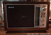 Front view of vintage Sony AM/FM table radio with control knobs and speaker.