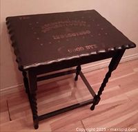 Full view of vintage wooden side table with scalloped top and Ouija board design painted on top surface, showing the twisted barley twist legs and overall structure.