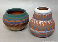 Front and side view of both vintage Navajo vases showing their shape and painted patterns.